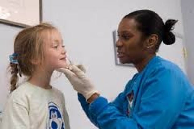 Pediatric patient receiving a nasal spray flu vaccine